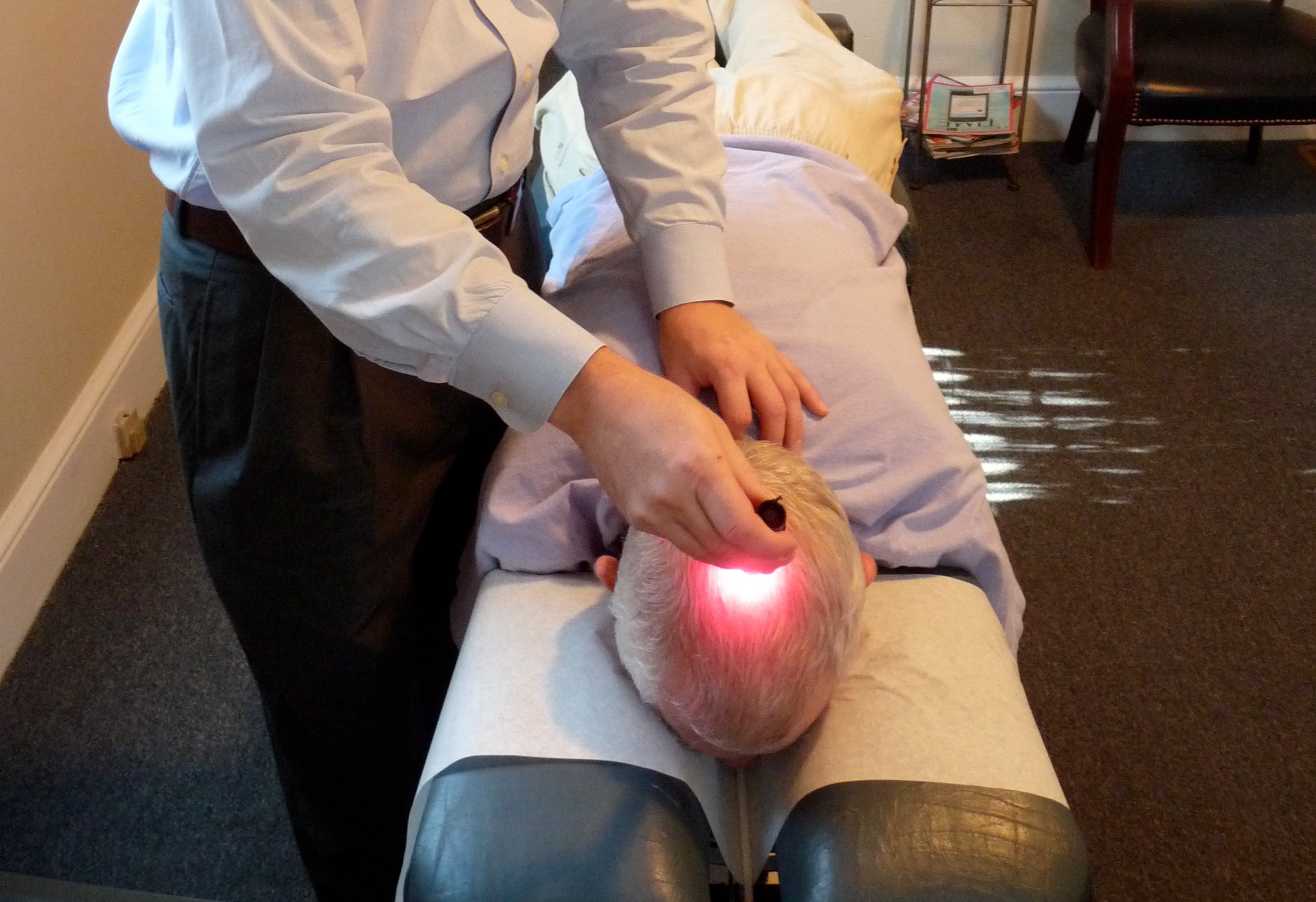 Dr. Nick Wise performing Cranial Laser Reflex Technique CLRT at Wise Chiropractic Pearl District Portland